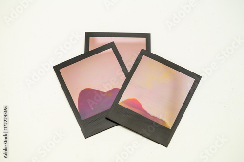 Failed Polaroid photo development — abstract patterns from improperly exposed instant film on white background