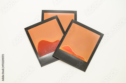 Failed Polaroid photo development — abstract patterns from improperly exposed instant film on white background