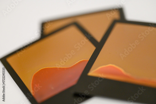 Failed Polaroid photo development — abstract patterns from improperly exposed instant film on white background