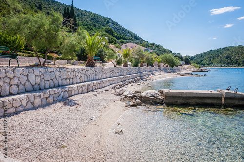 Scenic Adriatic coastal landscapes with clear blue sea, rocky beaches, pine trees, and tranquil bays