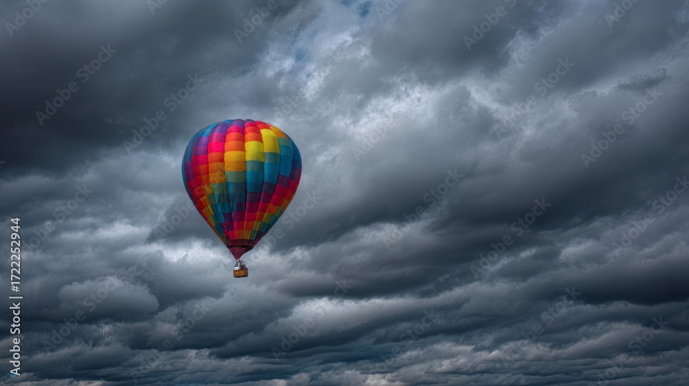 Obraz premium Colorful hot air balloon against stormy sky