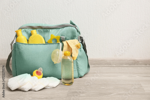 Baby bag with diaper on flo...