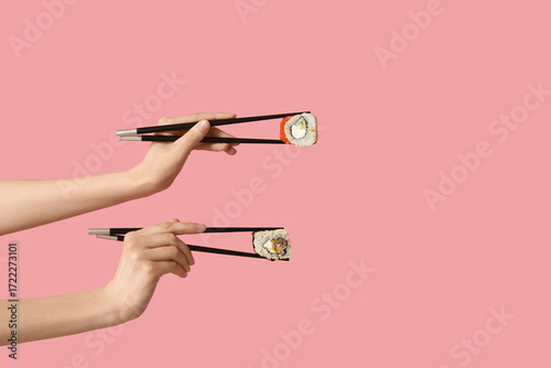 Female hands holding chopst...