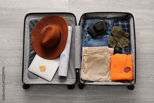 Open packed suitcase with c...