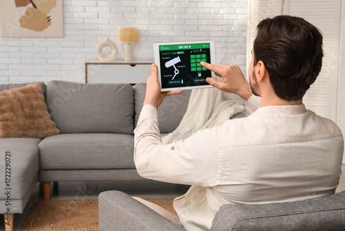 Young man using smart home ...