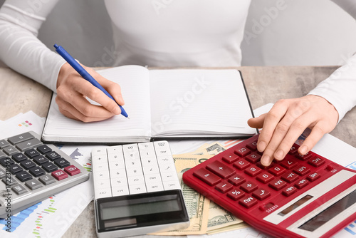 Woman with notebook, money ...