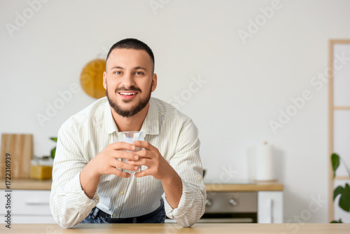 Young man with glass of mil...