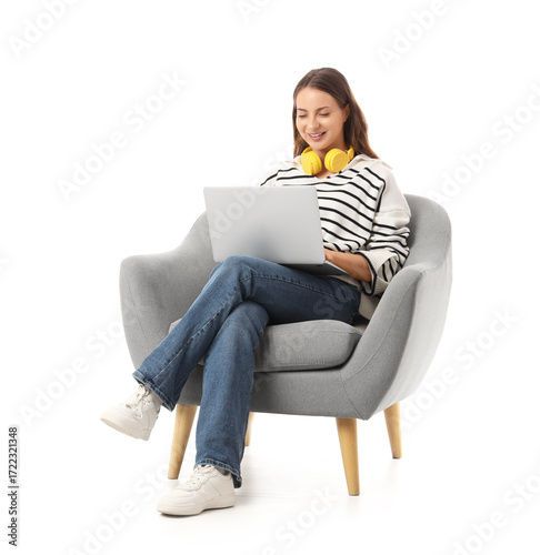 Young woman using laptop in...