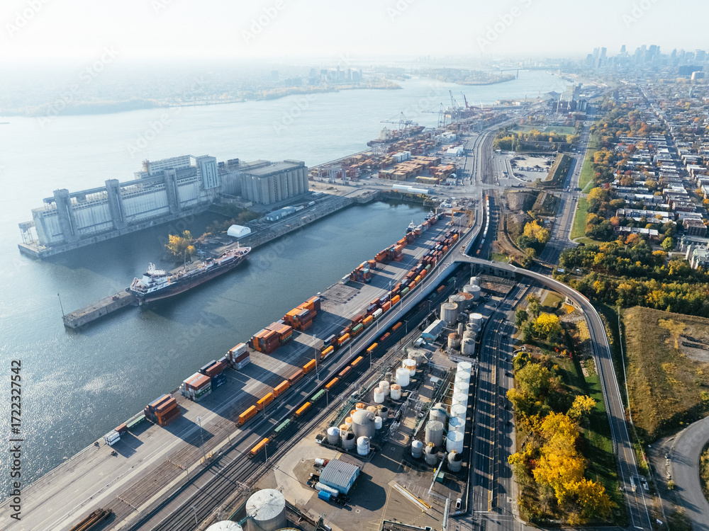 Naklejka premium Aerial view of port industrial tanks and container yard near river in Montreal, Canada. g.