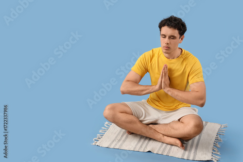 Young man meditating in lot...