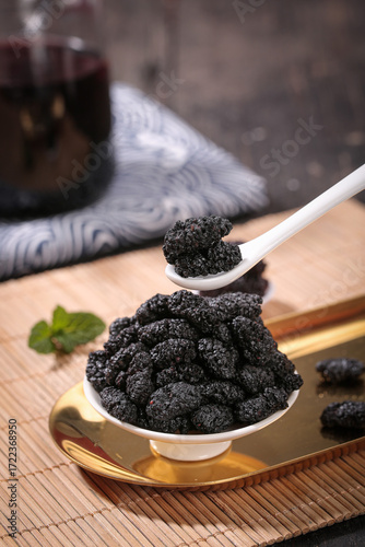 Xinjiang Dried Mulberries in Ceramic Spoon Closeup - Deep Purple Healthy Fruit Snack