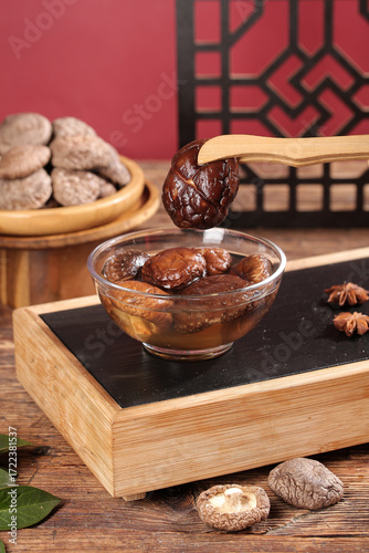 Fresh and Dried Shiitake Mushrooms on Wooden Tray with Asian Decor Background
