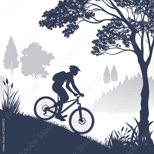 A mountain biker rides on a trail through a forest with trees, grass, and a lake in the background the silhouette of the cyclist is visible