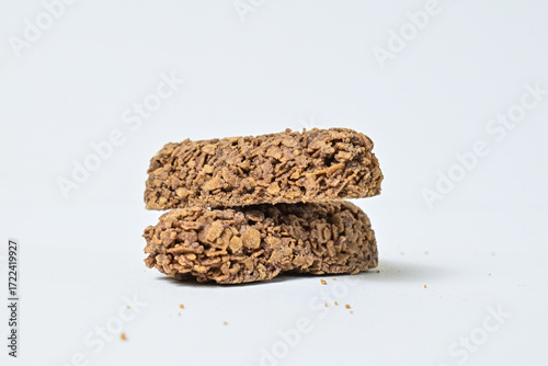 Cuadro en lienzo Close up view of teo cereal snacks or bars from oat meal isolated on white background