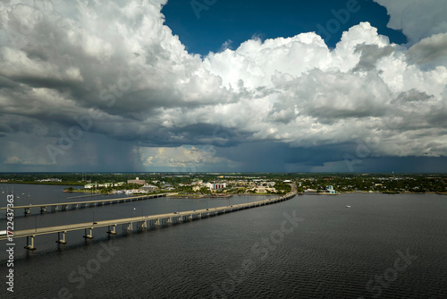 Wallpaper Mural Heavy thunderstorm approaching traffic bridge connecting Punta Gorda and Port Charlotte over Peace River. Bad weather conditions for driving during rainy season in Florida Torontodigital.ca