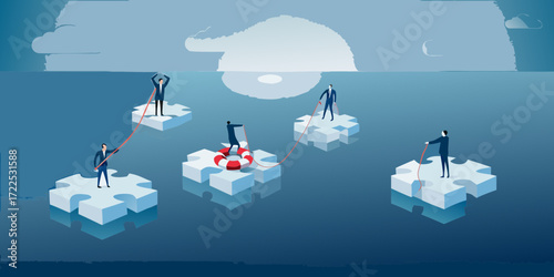 Businessmen on puzzle pieces in the ocean helping each other with a life preserver