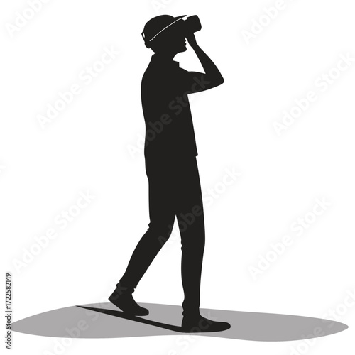 Silhouette of a person wearing a virtual reality headset and looking around while walking