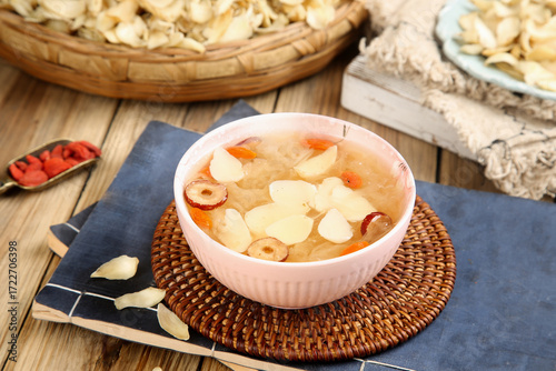 Chinese White Fungus Lily Soup with Red Dates and Goji Berries in Pink Bowl Traditional Asian Dessert