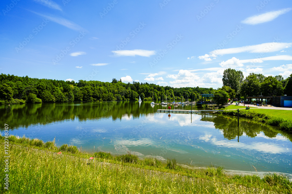 Fototapeta premium View of the Bucher Reservoir and the surrounding landscape. Nature near Rainau.