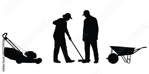 silhouette of a man pushing a wheelbarrow