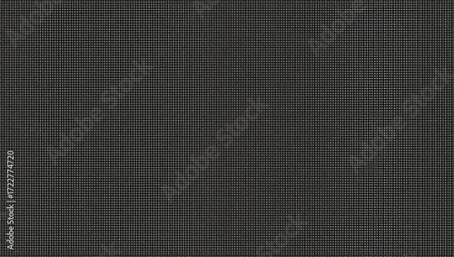A consistent, repeating grid pattern dominates this dark gray surface.