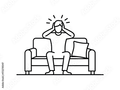 Person sitting on a couch holding their head in distress