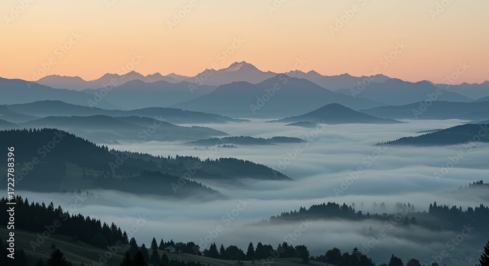 Fototapeta premium Serene mountain vista at dawn with soft fog rolling through valleys