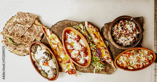 Delicious meat kebab with fresh vegetable salad served with variety of Turkish dishes and appetizers. Top view of assorted Turkish food and meze, tasty and healthy Mediterranean cuisine. Top view.