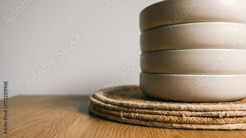 Quadro su tela Stacked bowls on a woven placemat