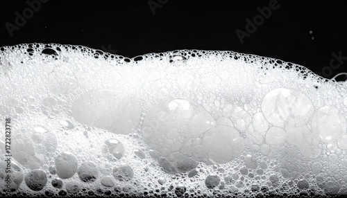 Soap, foam, bubbles, froth, and airy texture floating gracefully against a delicate black background, highlighting purity, freshness, and cleanliness, with elegant copy space, perfect for hygiene, des