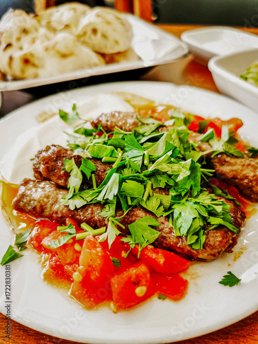 Delicious meat kebab with fresh vegetable salad served with variety of Turkish dishes and appetizers. Top view of assorted Turkish food and meze, tasty and healthy Mediterranean cuisine. Top view.