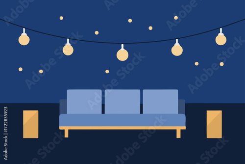 Cozy outdoor seating area with string lights and a comfortable blue sofa at night