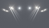 Bright white spotlights with intersecting beams of light on a transparent background. A realistic stage lighting effect for concerts, theaters, fashion shows, and digital design compositions.