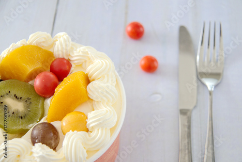 Close-up on a wooden table cream with kiwi, cherry tomatoes, depth of field