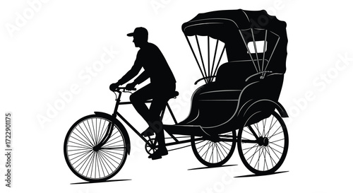 Silhouette of a rickshaw puller riding a bicycle in black and white