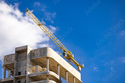 Tableau sur toile High rise building under construction in evening sky