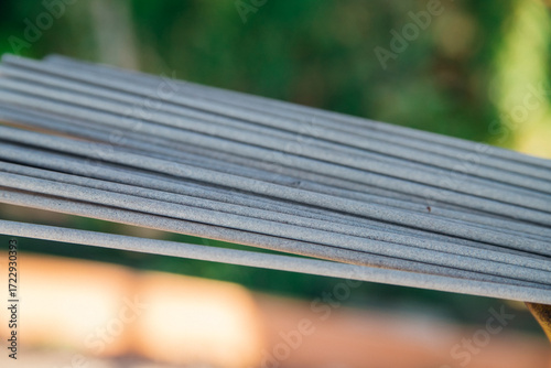 Welding electrode in the hands of a person at work. Profession: welder, working specialty, equipment, tools for welding metals.