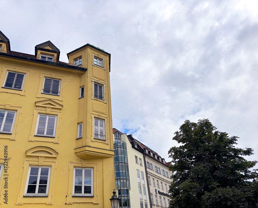 Fototapeta premium An amazing combination of architectural styles from different eras is noted by a traveler on the streets of Munich on a warm summer day.