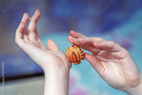 Wallpaper Mural Elegant female hands performing self-massage on palms and wrists with a wooden honey suckle ball Torontodigital.ca