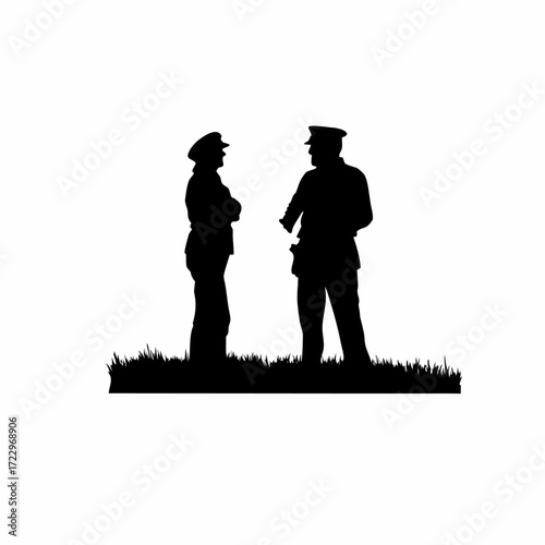 Silhouette of two officers in a field one talking to another silhouette