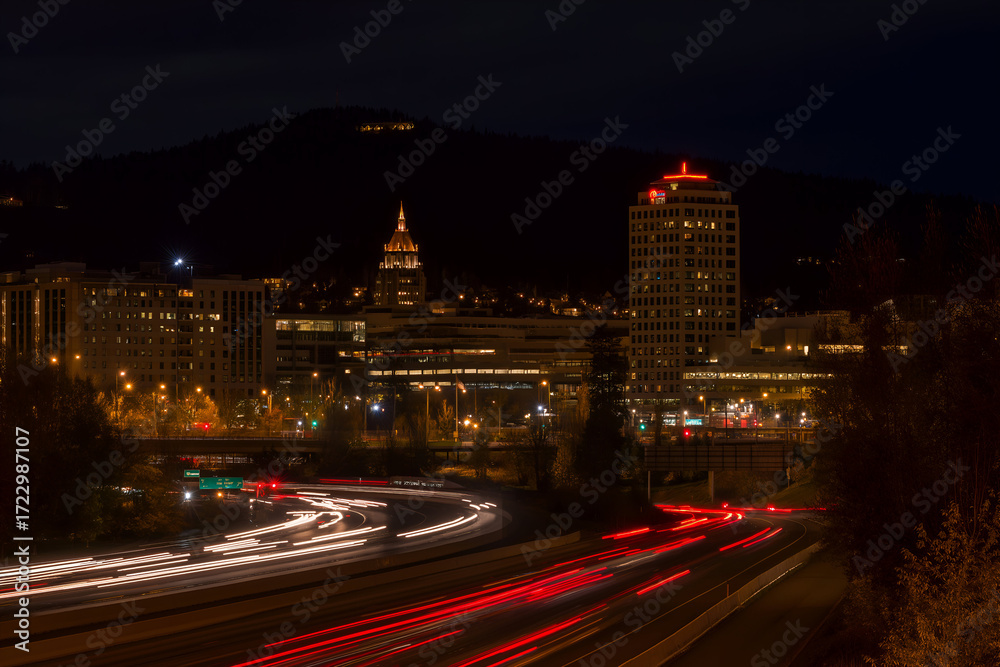Fototapeta premium City Skyline at Night with Red and White Light Streaks. Mock up promotion information for marketing announcements and details, blank white space.