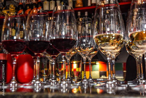 Glasses of red and white wine on the table