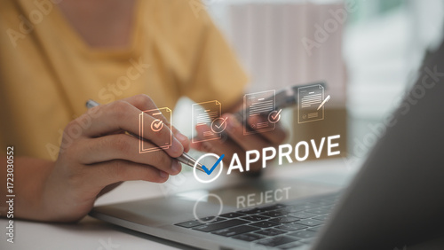Digital document approval process with person confirming files on laptop. Concept of e-approval, online verification, business workflow, and paperless office solutions for modern organizations.