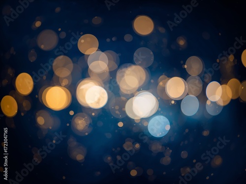 An abstract background of festive blue and gold bokeh lights on a dark backdrop.