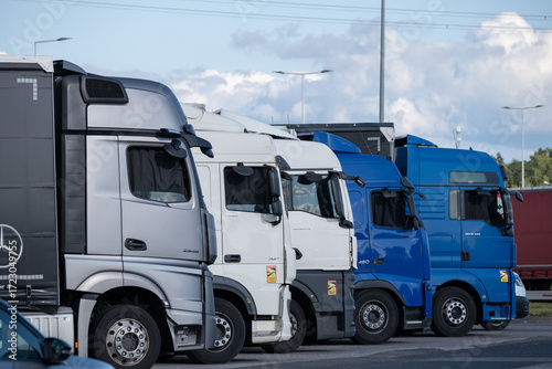 Row of parked trucks in a logistics parking area