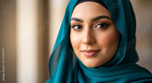 Elegant portrait of a beautiful muslim woman in a turquoise hijab veil