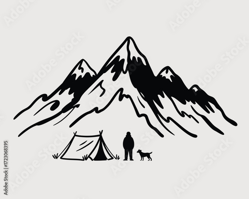 Silhouette of a person and dog camping in front of rugged mountains