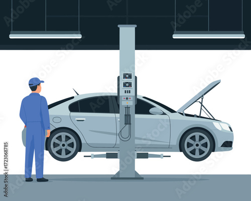 Mechanic inspecting car lifted on hydraulic car lift in auto repair shop