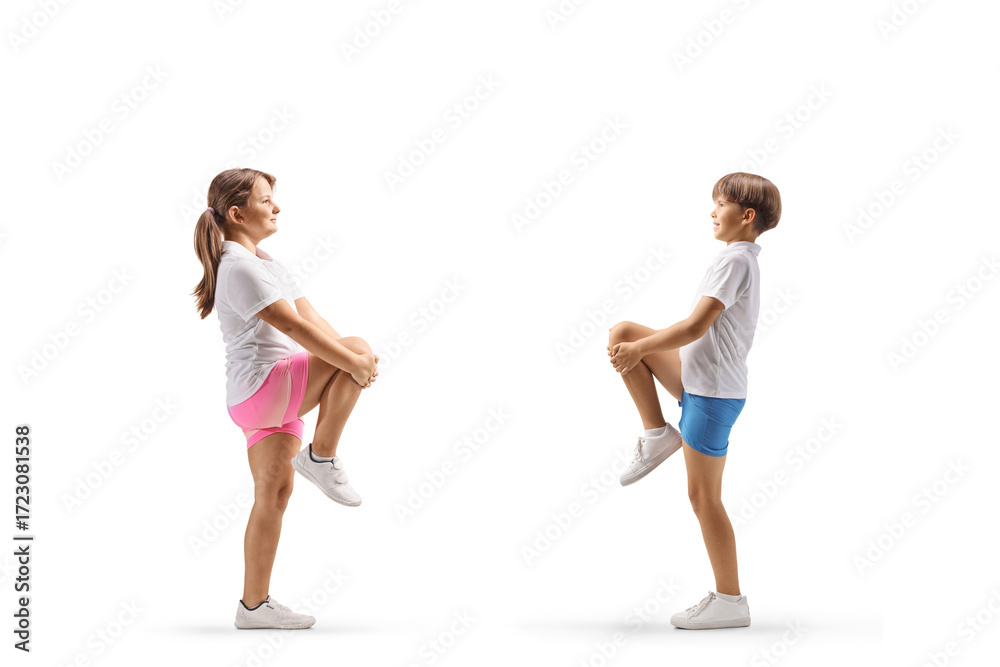 Obraz premium Full length profile shot of children stretching knees