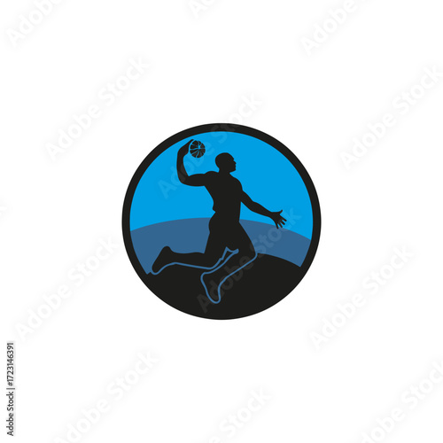 Silhouette of a basketball player mid air during a dunk